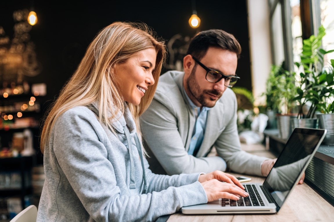 Two people looking at a laptop